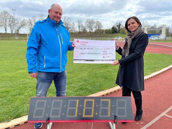 Tasso Hanke, Verbandsvorsitzender Leipziger Leichtathletik-Verband e. V., nahm den symbolischen Spendenscheck aus den Händen von Barbara Bauer, stv. Pressesprecherin der Sparkasse Leipzig, entgegen. Foto: Sparkasse Leipzig
